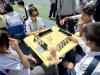 Students are engaged in an exciting Rummikub game, demonstrating their strategic thinking and teamwork during the competition.