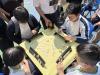 Students are concentrated and focused during the thrilling competition, fully immersed in the excitement of the game.