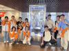 Students are visiting "Beijing Shougang Basketball Club" and they are amazed at the trophy.