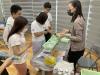 Students take materials from the booth with their parents.