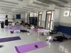 Teachers take a break under the guidance of the yoga tutor. 