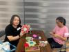 The two mothers are satisfied with their beautiful handicrafts.
