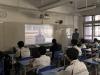Class teacher and students are watching the military parade live in the classroom.