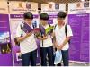 Students review a booklet detailing various faculties and academic programmes.