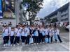Students have a group photo at The University Mall.