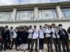 Students take a group photo in front of the Antiquities and Monuments Office.
