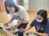 Parents working together to create the succulent potting.