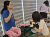 Workshop tutors guiding the parents to make the succulent potting flower.