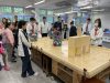 Students demonstrating robotic coding skill in smart Home Lab.