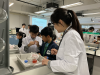 Students learning about DNA and cellular structure of fruits.