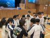 Students huddle together during an activity. 