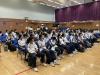 Students listen attentively to their house captains.