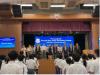 Students sing the school song during the opening ceremony.