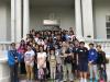 All participants are posing for a photo at the Airport Core Programme Exhibition Centre.