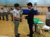 Principal Wong Chung Ki was presenting the Senior Patrol Leader Badge to Yung Mo Kin (a KTC student).