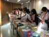 Many students are enjoying reading in the book fair.