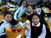 The girls are enjoying the fruits during lunchtime.