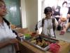 A student is pretending to be a hawker selling a traditional snack of Hong Kong.